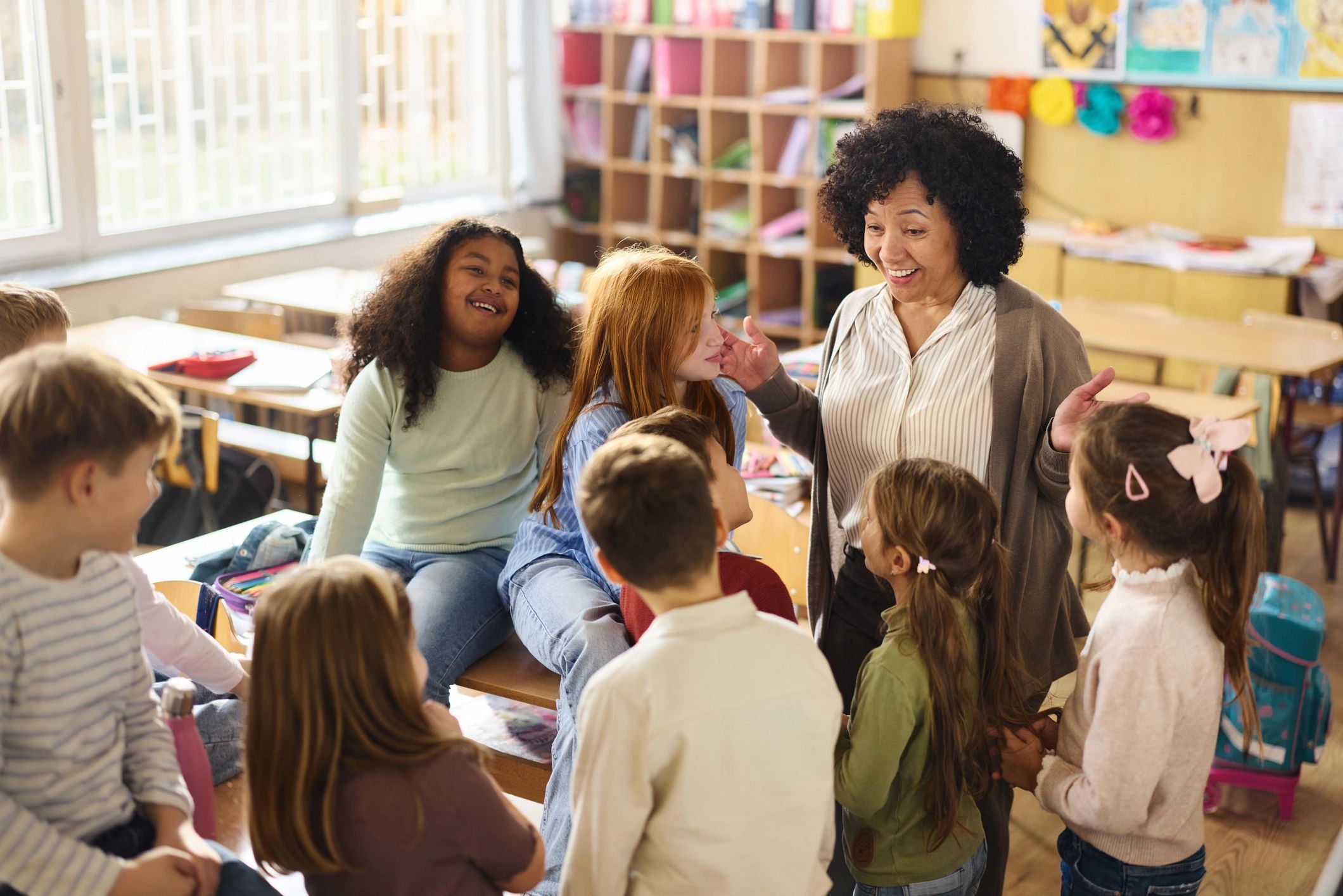 Teacher connecting with children in a bright classroom