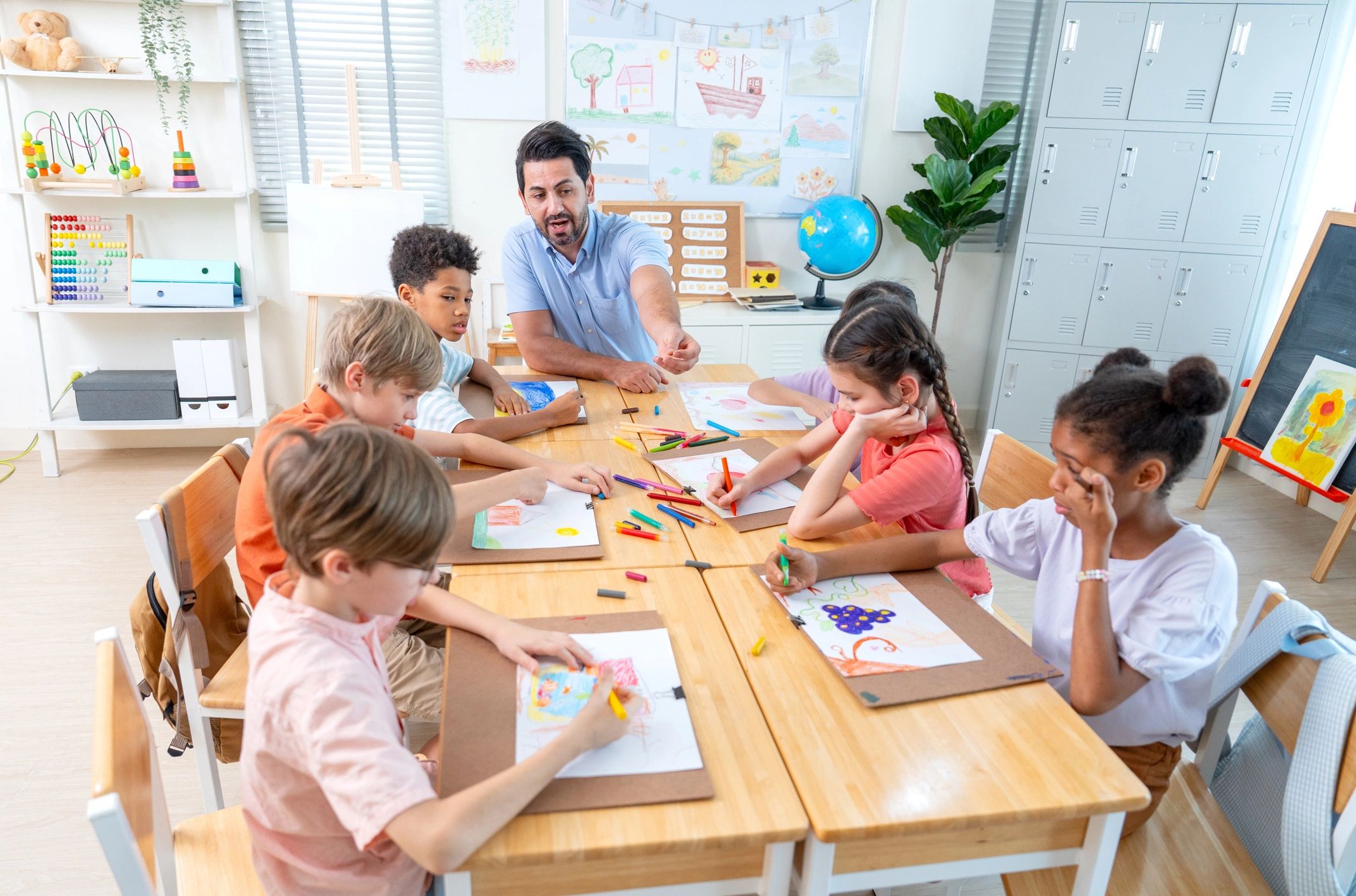 Teacher guiding children during a creative classroom activity